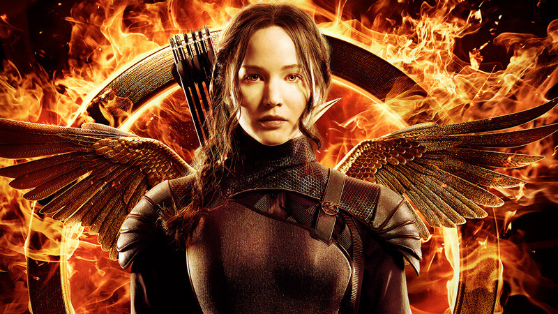 Katniss em detalhe de cartaz de filme da série Jogos Vorazes