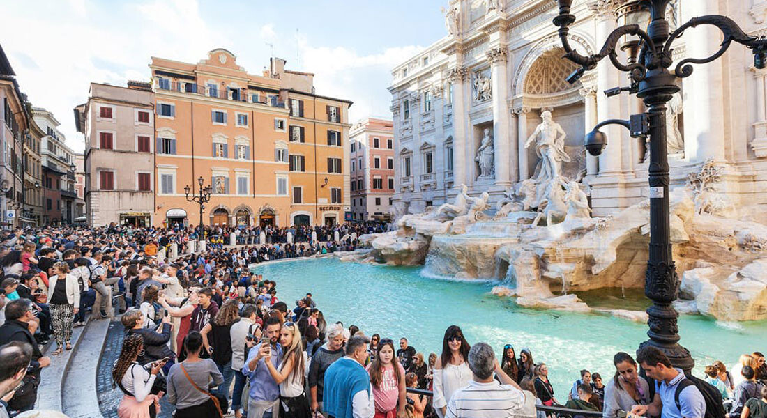 Foto de turistas aglomerados ao redor da Fontana di Trevi