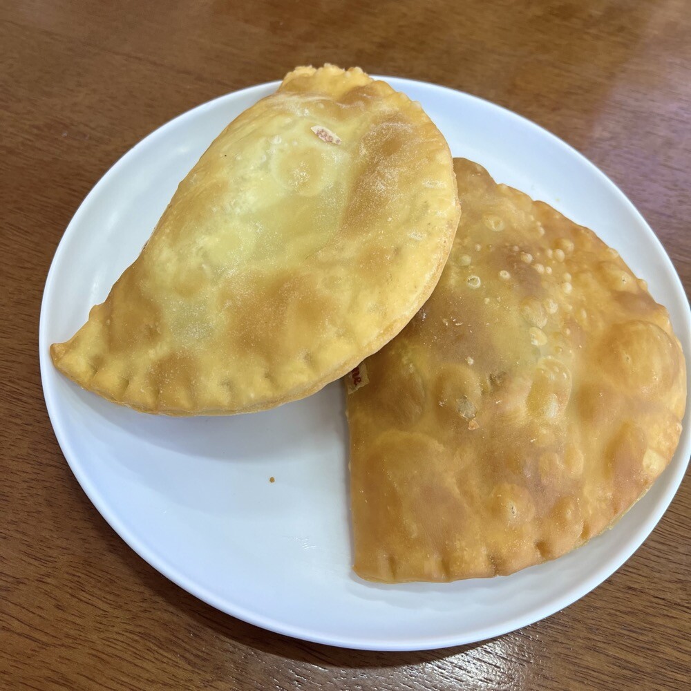 Dois pastéis servidos em um prato branco 