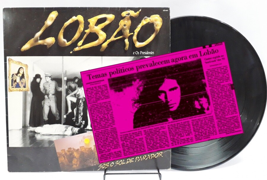 Recorte de matéria da Folha, com o título “Temas políticos prevalecem agora em Lobão“, e o disco da ocasião - Luar sobre Parador, por “Lovão e os Presidentes“