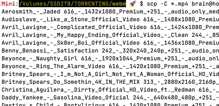 Tela de um terminal mostrando um comando scp transferindo arquivos cujos nomes começam com Aerosmith, Audioslave, Avril Lavigne, Benny Benassi, Beyonce, Britney Spears, Christina Aguilera e Daddy Yankee