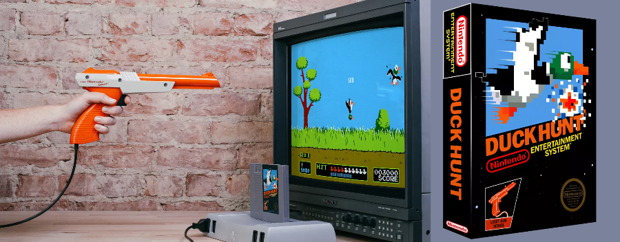 Foto de uma pistola zapper apontada para uma TV com uma tela do jogo, e foto de um cartucho do jogo