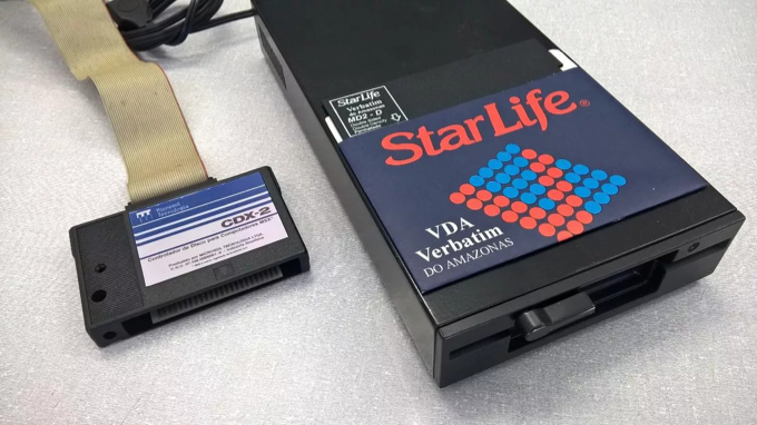 Uma interface controladora CDX-2, da Microsol, ao lado de um disk drive de 5¼ com seu próprio cabo de alimentação elétrica.