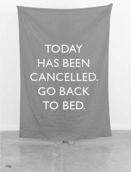 Foto em preto e branco onde uma pessoa de saltos altos segura um lençol onde está escrito: <br><br>TODAY HAS BEEN CANCELLED. GO BACK TO BED.