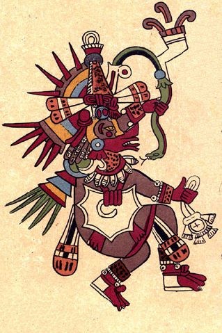 imagem da divindade originária americana Quetzalcoatl, repleta de adereços profusamente coloridos, e segurando um objeto cujo desenho foi apenas contornado, e não pintado.
